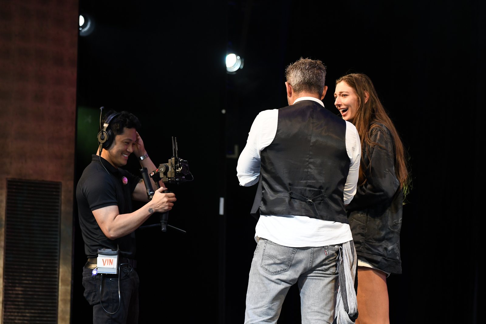 Phoenix talking a volunteer through the show on stage